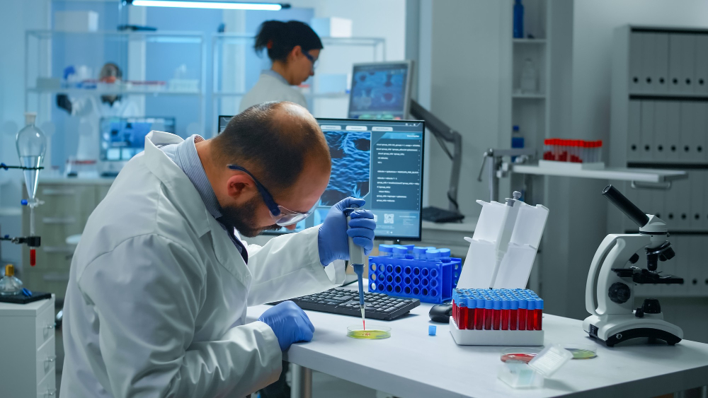 Laboratory technician performing genomic analysis and comparison with conventional testing methods