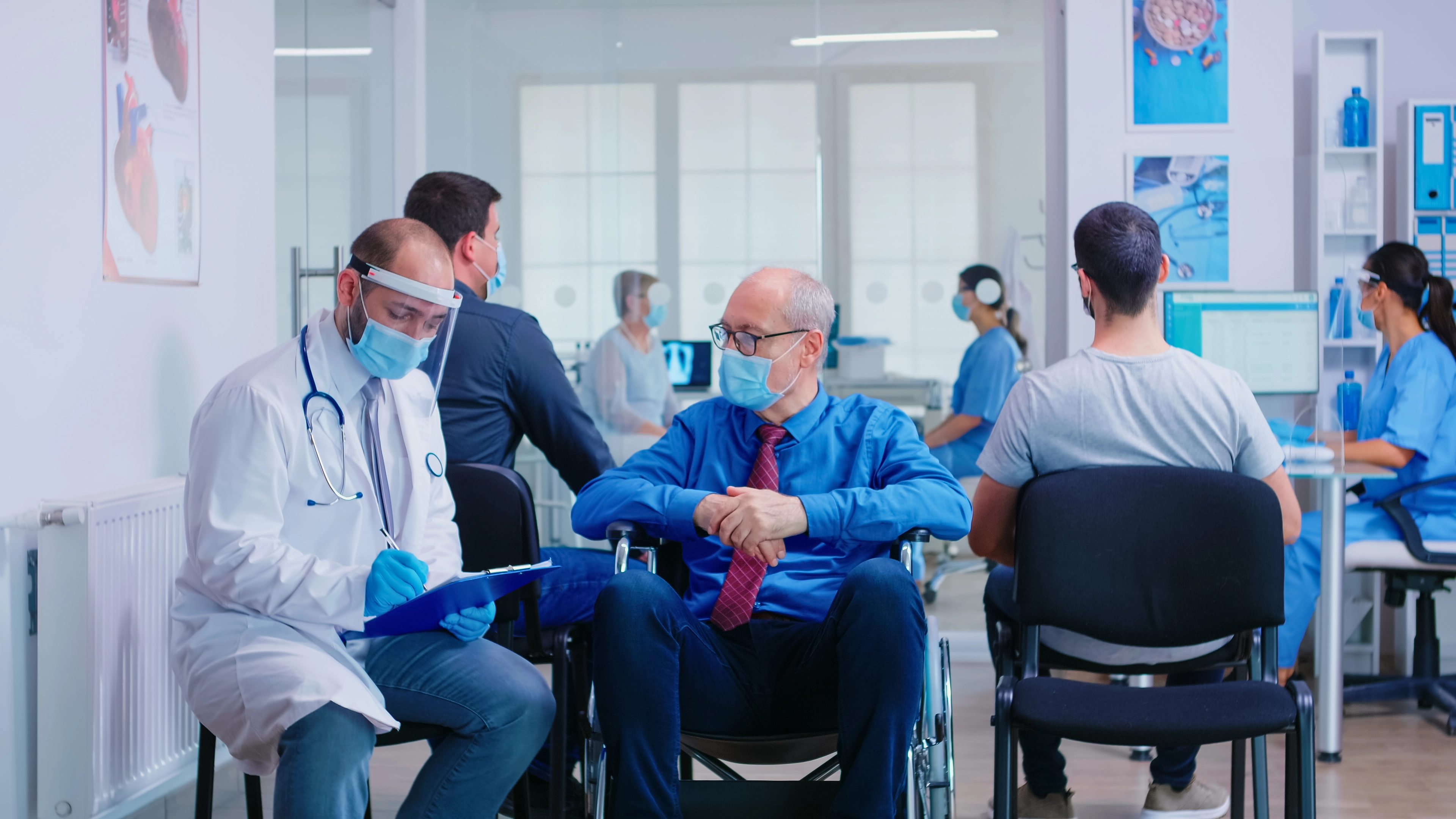 Doctor consulting with patient in hospital waiting area